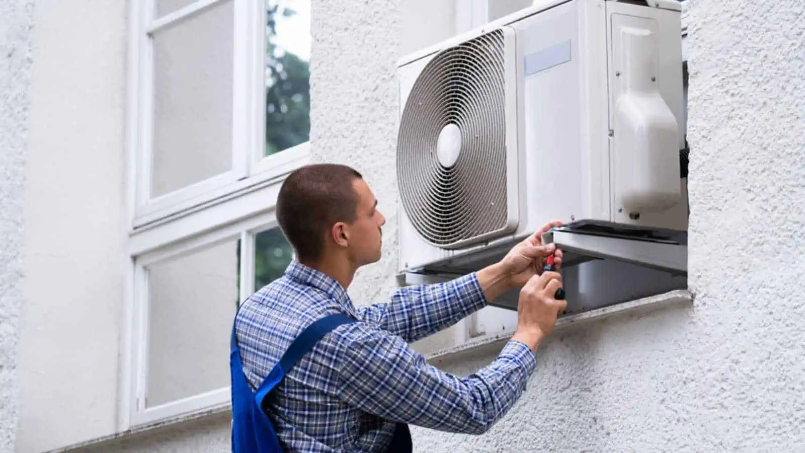 Mechanic repairing Window Air Conditioner