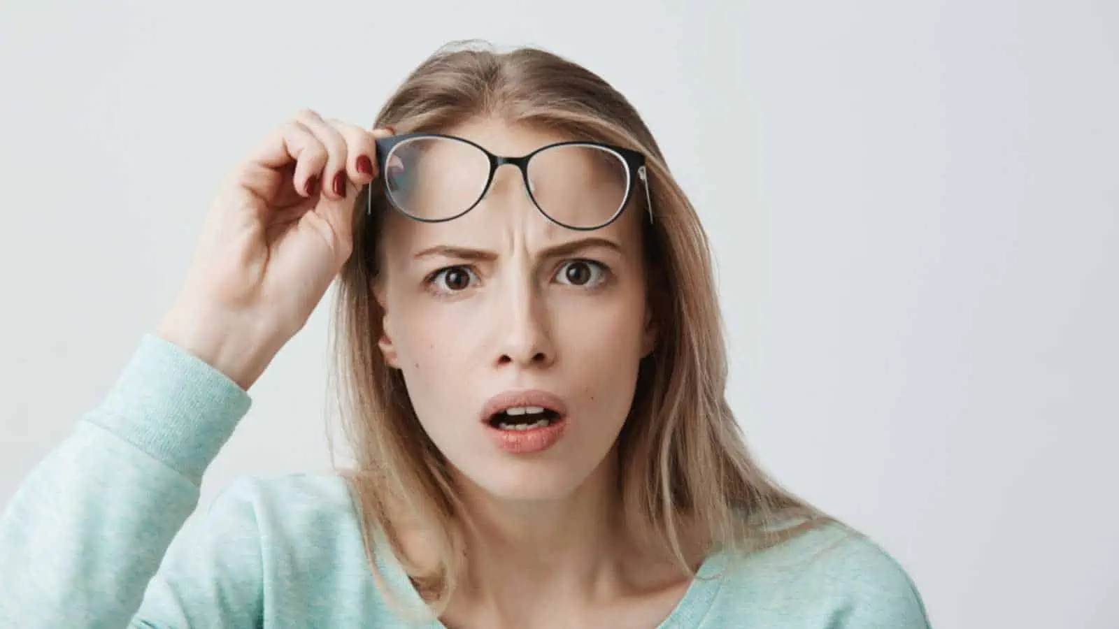 Woman shocked and removing specs