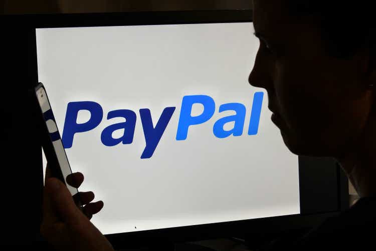 :Silhouette of upset Australian woman over PayPal logo