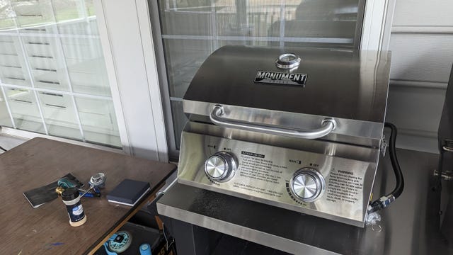 Small silver grill on a metal table