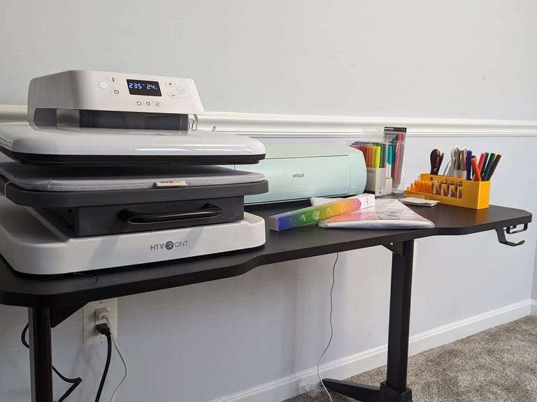 Large heatpress next to a green Cricut machine