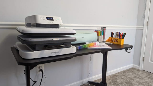 Large heatpress next to a green Cricut machine