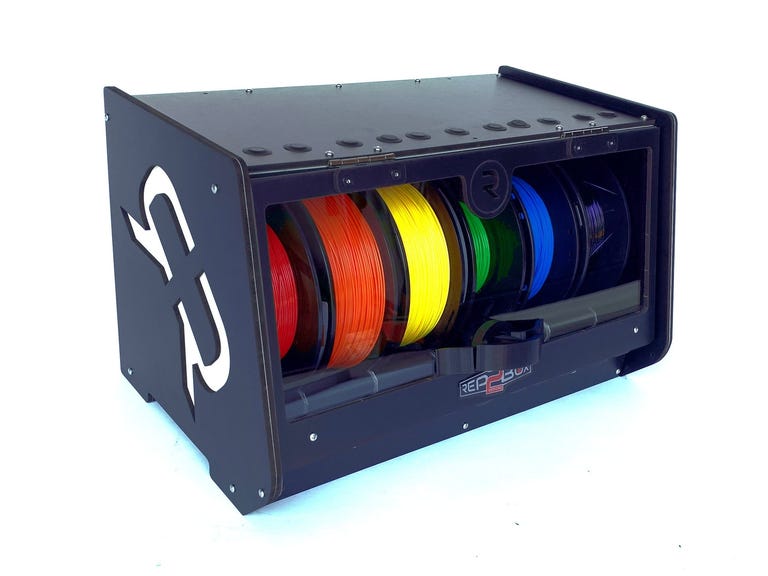 A black wooden box with 6 different color filaments inside