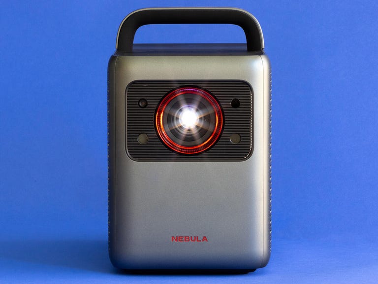 An Anker Nebula Cosmos projector against a blue background.