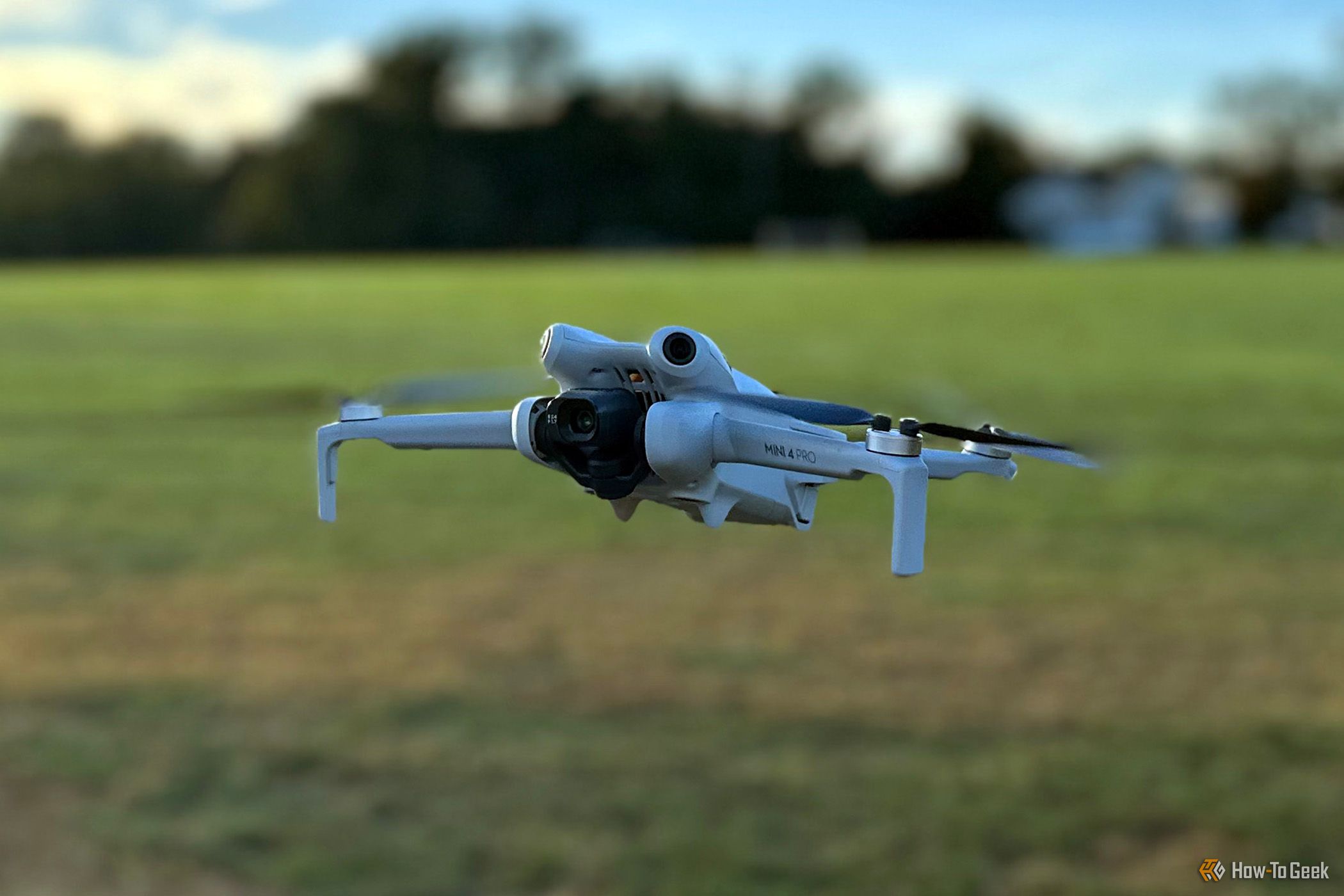 DJI Mini 4 Pro in flight at a park