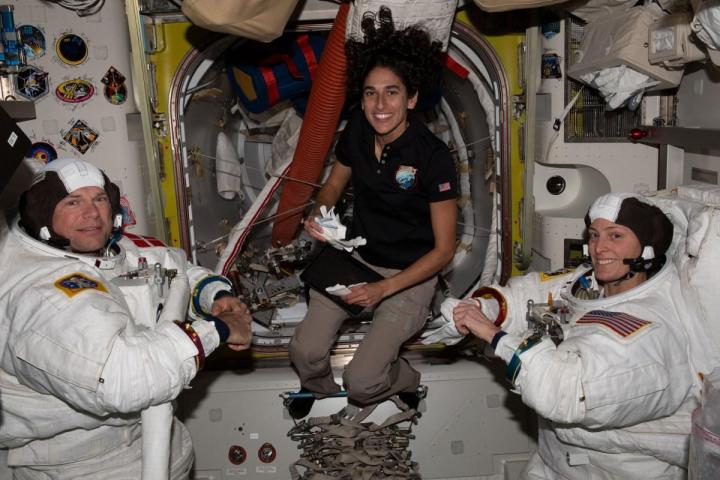 NASA astronaut Jasmin Moghbeli (center) assists astronauts Andreas Mogensen (left) from ESA (European Space Agency) and Loral O’Hara (right) from NASA as they try on their spacesuits and test the suits’ components aboard the International Space Station’s Quest airlock in preparation for an upcoming spacewalk.