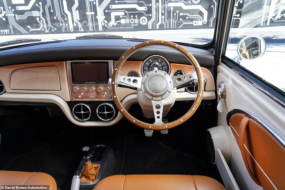 The interior has been brought up to date with modernised retro styling, including a rivetted wood steering wheel and chunky metal switchgear