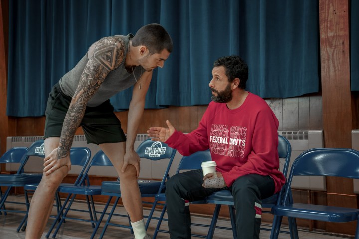 Bo Cruz leans down while talking to Stanley Sugarman in Hustle.