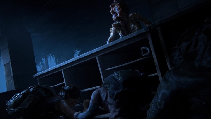 Ellie and Joel hiding behind a desk from a clicker in The Last of Us Remake.