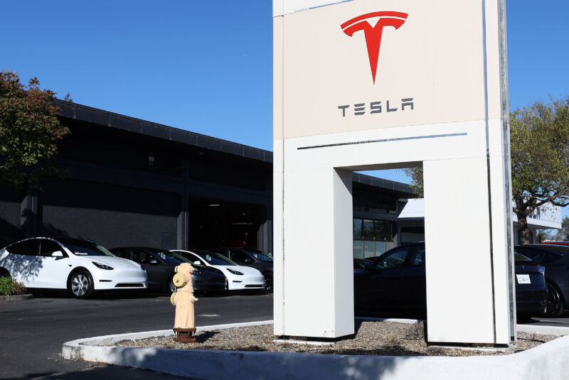 Brand new Tesla cars sit parked at a Tesla dealership on October 18, 2023 in Corte Madera, California.