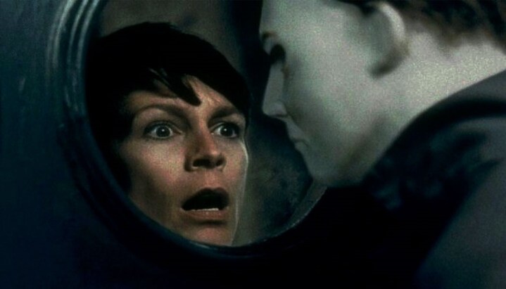 Laurie Strode seeks the masked Michael Myers through a window in Halloween H20