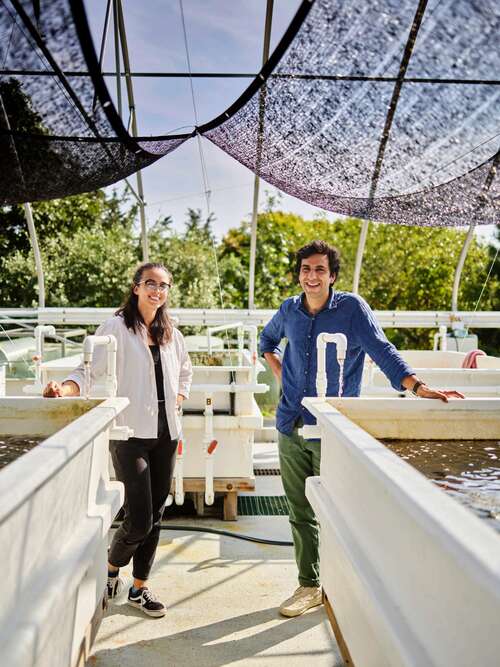 Dean and Subhas pose next to tanks