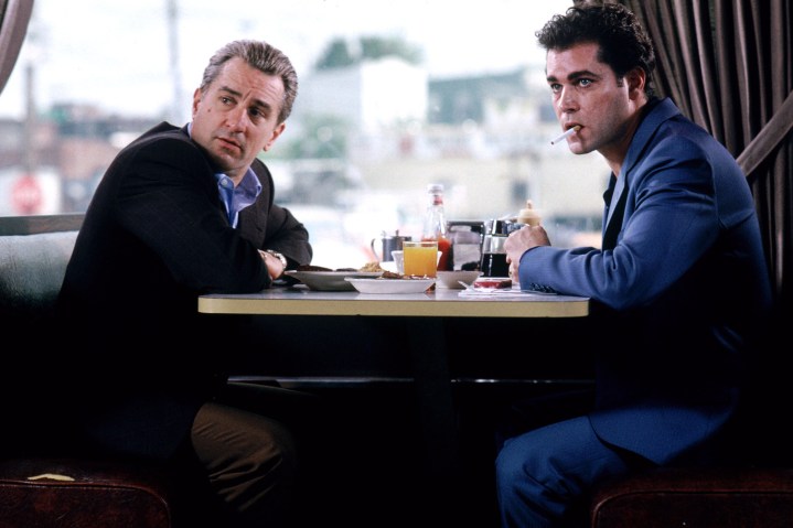 Robert De Niro and Ray Liotta sit at a diner booth together in Goodfellas.