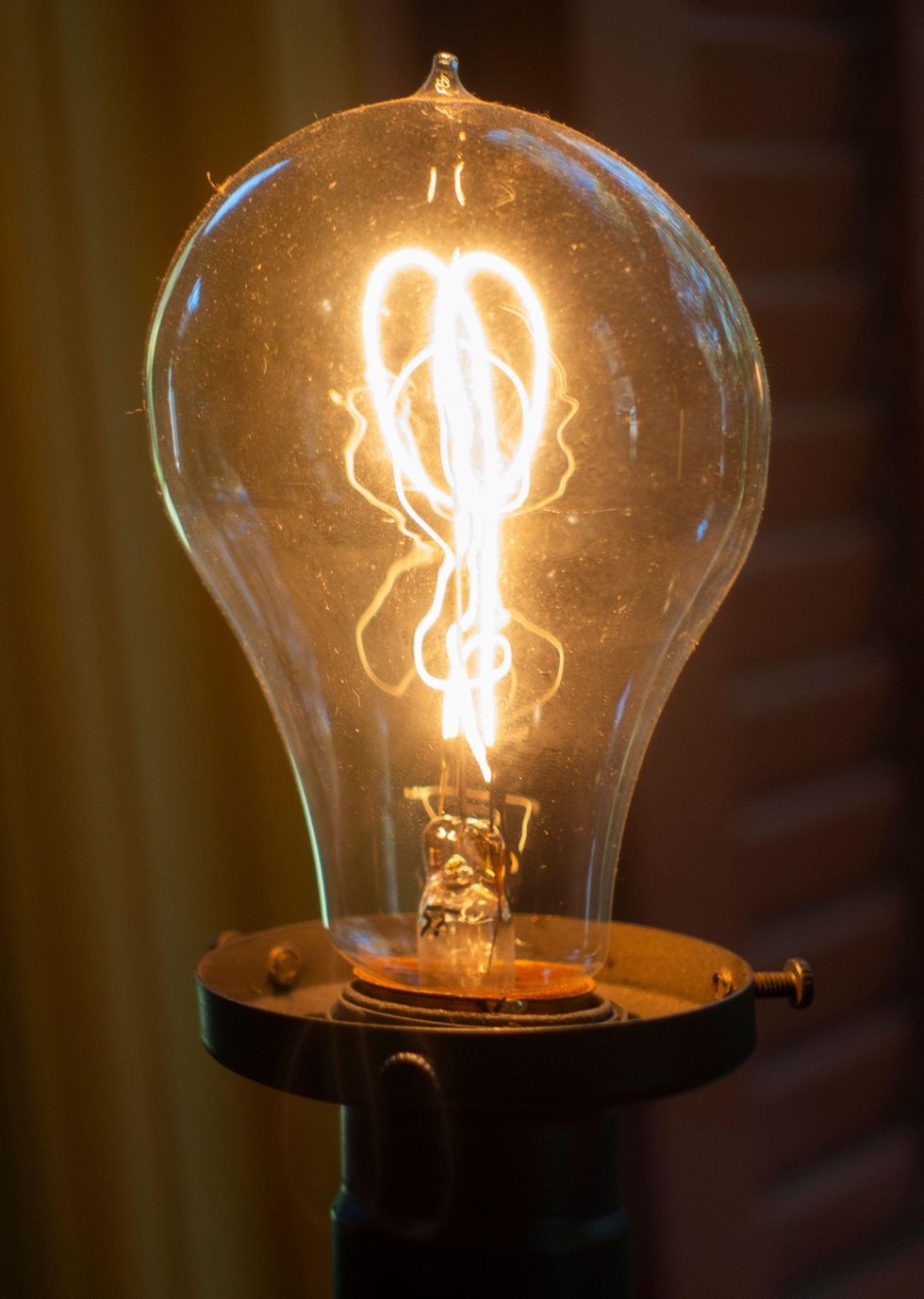 A lightbulb with a glowing filament.