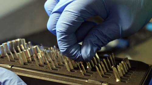 Person removing a screw driver bit from the Person using the iFixit Pro Tech Toolkit