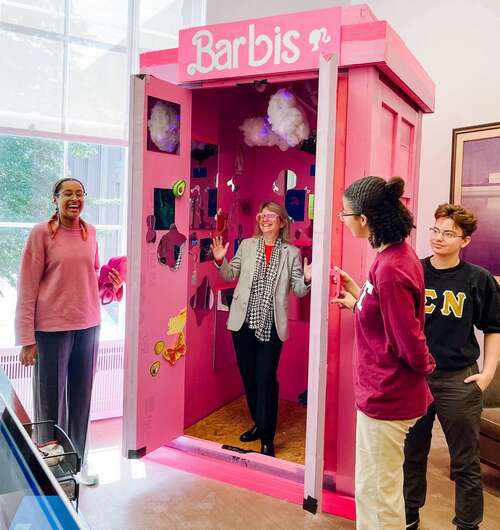 Sally Kornbluth in the Barbis with students standing to the left and right