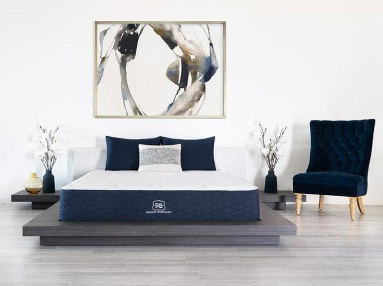 A mattress from Brooklyn Bedding Signature on a nice bed frame in a bright bedroom. 