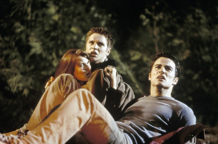 Three teen sit and stare in horror in Final Destination.