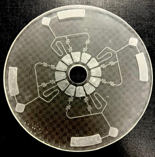 a transparent circle with a symmetrical white pattern of channels