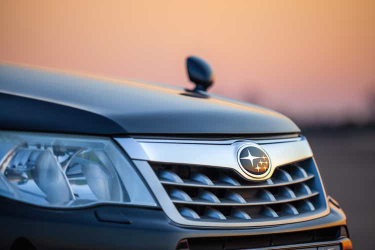 Subaru grill with logo in front of sunset