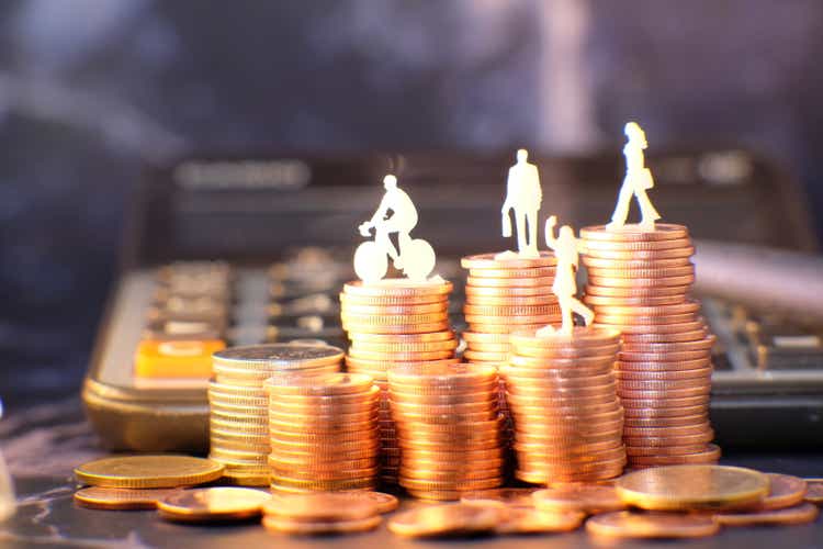 Coins stacked background and advertising coins of finance and banking, increasing columns of gold coins on table