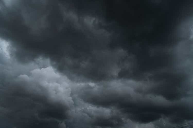 Dark thunderstorm clouds rainny landscape. Meteorology danger windstorm disaster climate. Dramatic dark storm thundercloud rain clouds on black sky background.Dark cloudscape storm disaster gray sky