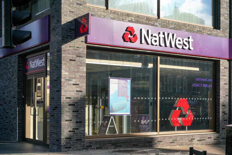 Sun shines on stone bricks wall at one of National Westminster Bank branches