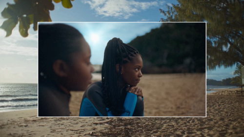 Young Black kid listening intently to scuba instructor