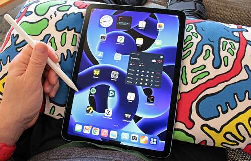 Apple iPad 5th generation in front of a colorful background