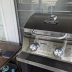 Small silver grill on a metal table