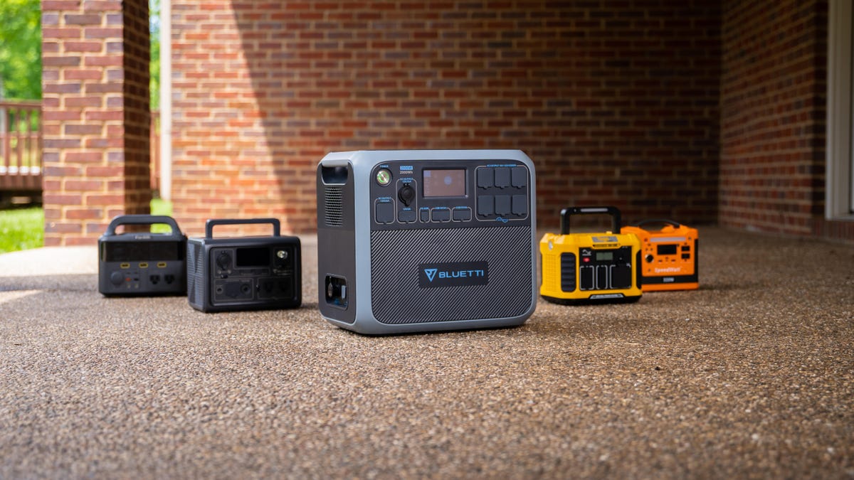 Five power stations in front of a brick wall