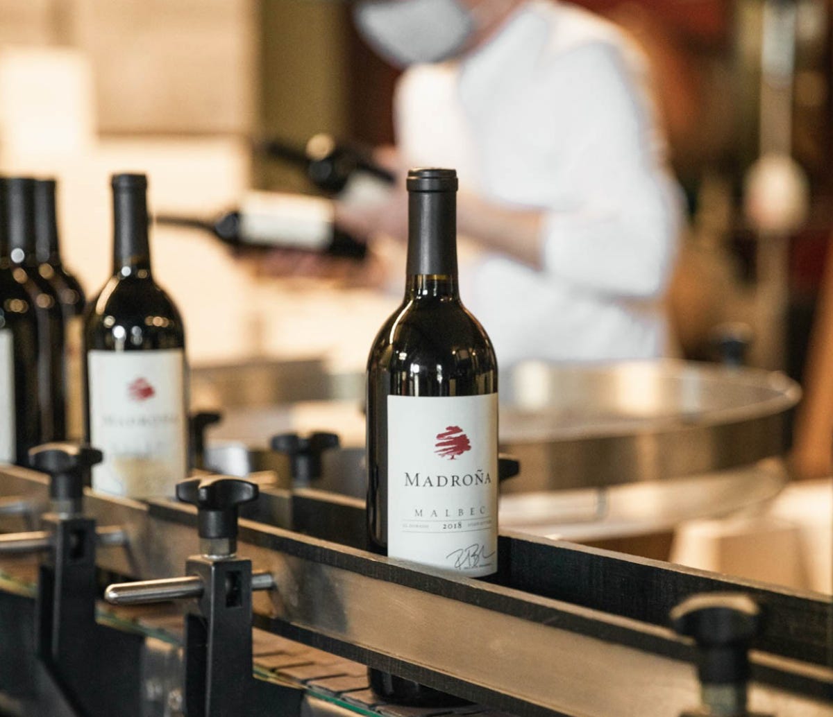 bottles of wine in bottling machine