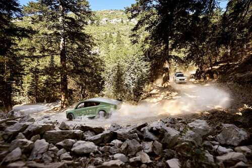 a solar-powered car driving down a mountain pass in morocco