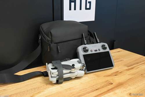 DJI MIni 4 Pro, RC 2 remote controller, and storage bag on a wood tabletop