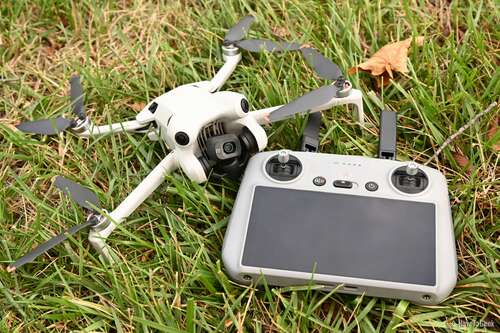 DJI Mini 4 Pro and Controller Laid in the Grass