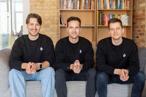 three men sat on gray sofa