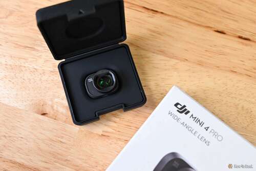 DJI Mini 4 Pro Wide-Angle Lens open on a wood tabletop with its manual