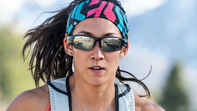 A woman running while wearing a pair of Bose Frames Tempo