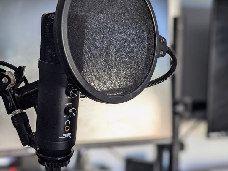 Microphone on a stand in front of a computer screen