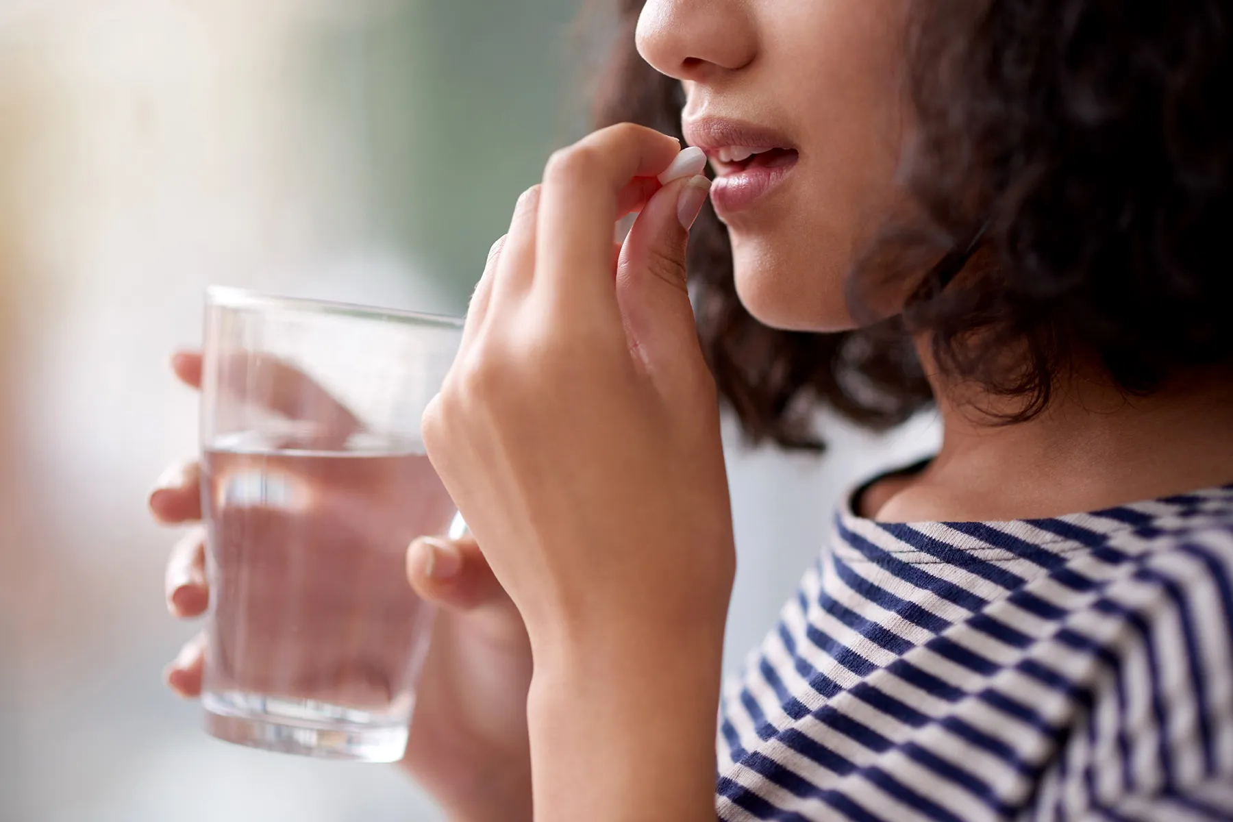 photo of woman taking supplement