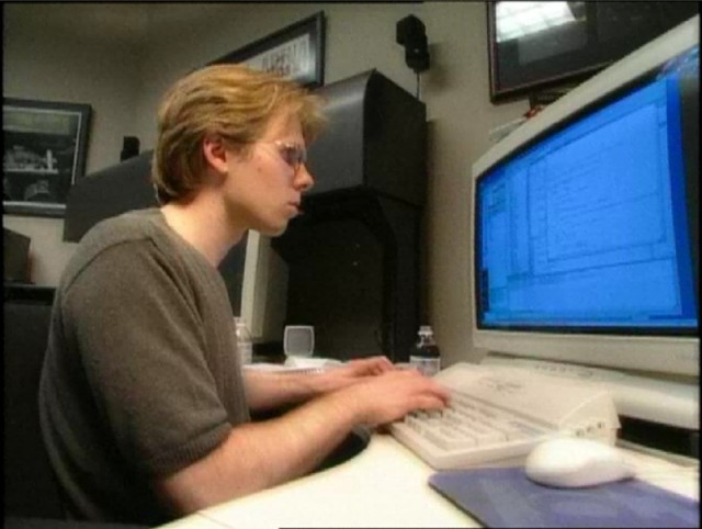 A young Carmack hard at work writing code.