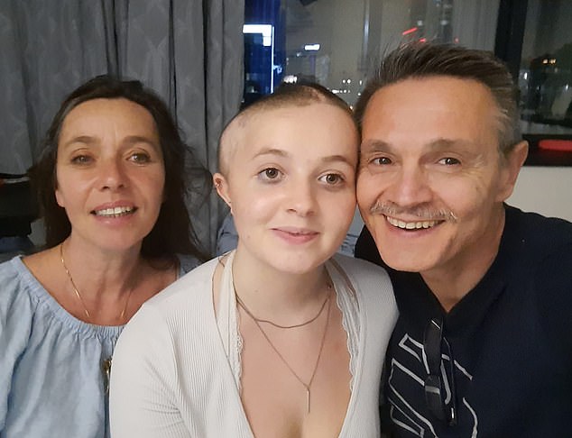 Recovering: Katya in hospital in Cape Town with mother Marsha and father Roberto after her second operation