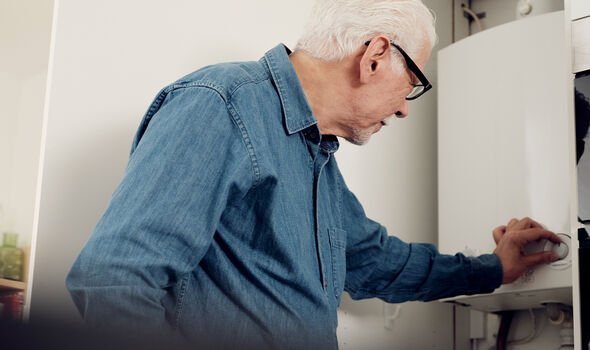 Man adjusting boiler temperature