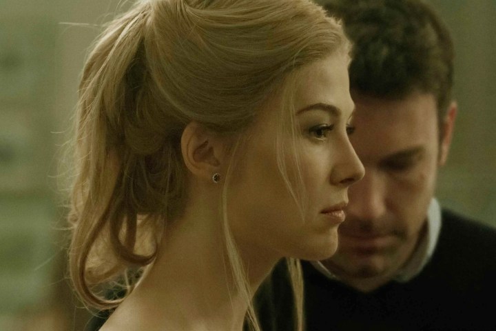 Ben Affleck stands next to Rosamund Pike in Gone Girl.