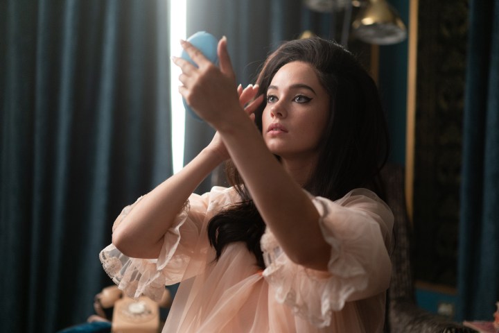 Cailee Spaeny looks up at a makeup mirror in Priscilla.