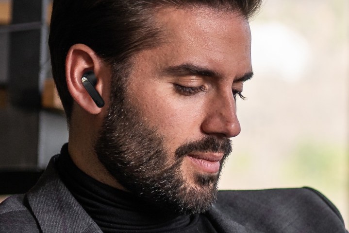 Man wearing Creative Aurvana Ace wireless earbuds.