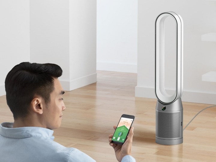 The Dyson Purifier Cool TP07 smart air purifier and fan in a room with a man.