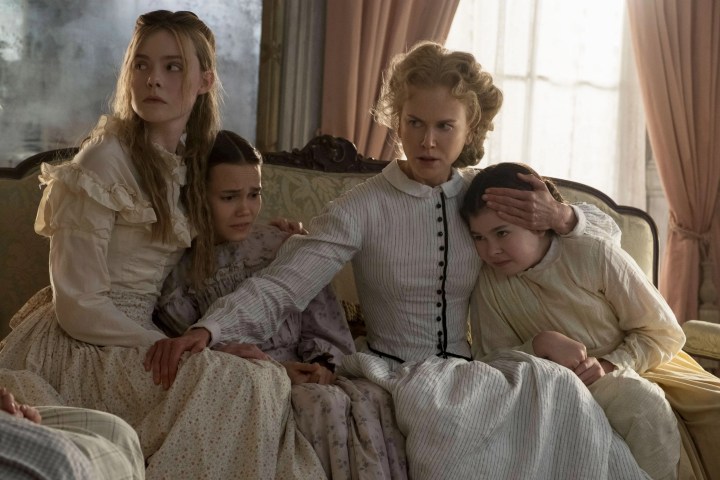 Elle Fanning and Nicole Kidman sit on a couch together in The Beguiled.