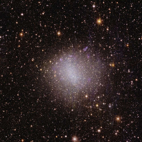 A square astronomical image is speckled with numerous stars visible across the black expanse of space. Most stars are visible only as pinpoints