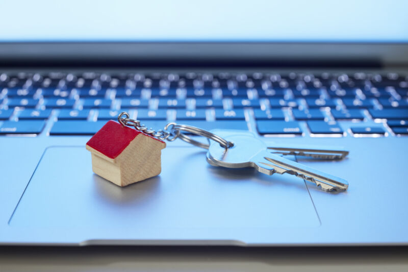 House keys on top of a Mac-like laptop trackpad